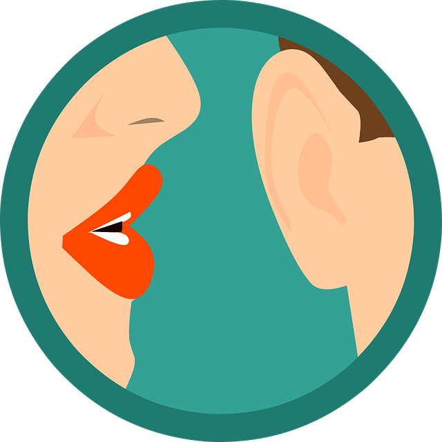 A woman speaking in a man's ear.