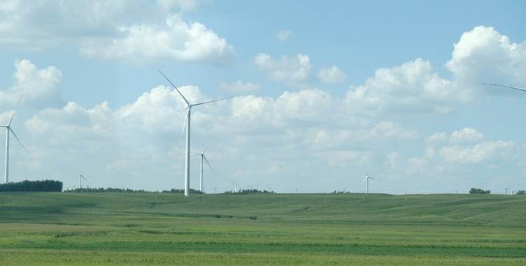 Wind turbines in a field with Codrington Wind Farm in the background

AI-generated content may be incorrect.