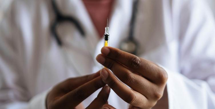 Close-up of a doctor holding a syringe

AI-generated content may be incorrect.