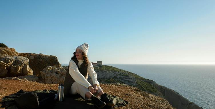 A person sitting on a rocky hill

AI-generated content may be incorrect.