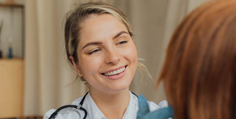 Doctor checking her patient's glands