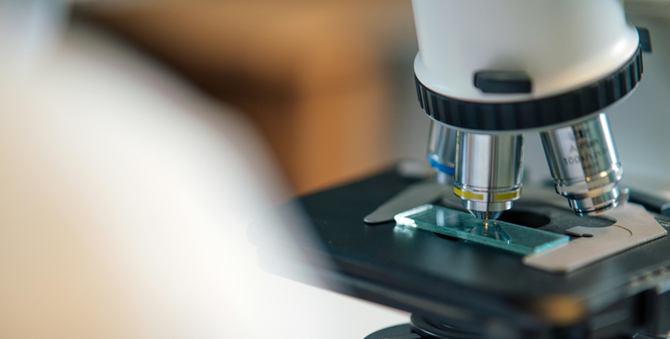A close-up of a microscope and sample slide
