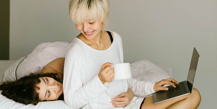 A person holding a cup and lying on a bed

AI-generated content may be incorrect.